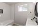 Clean bathroom featuring a shower and tub combination, a sleek vanity, and a round mirror above the sink at 506 W Seldon Ln, Phoenix, AZ 85021