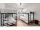 Spacious bedroom with two bunk beds, wood flooring, and a modern light fixture at 506 W Seldon Ln, Phoenix, AZ 85021