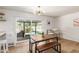 Bright dining area with modern light fixture, sliding glass doors to the backyard, and a wood dining table set at 506 W Seldon Ln, Phoenix, AZ 85021