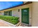 Inviting entryway featuring a secure, decorative green door and lush greenery at 506 W Seldon Ln, Phoenix, AZ 85021
