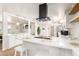 Well-lit kitchen featuring a functional island, pendant lights, and stainless steel appliances at 506 W Seldon Ln, Phoenix, AZ 85021