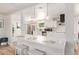Bright and airy kitchen with a large island, modern lighting, and stainless steel appliances at 506 W Seldon Ln, Phoenix, AZ 85021