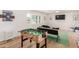 Inviting living area with a foosball table, stylish decor, and abundant natural light at 506 W Seldon Ln, Phoenix, AZ 85021
