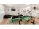 Open living space featuring a game table, modern decor, and seamless kitchen access at 506 W Seldon Ln, Phoenix, AZ 85021