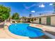 Beautiful backyard featuring a sparkling swimming pool and well-maintained landscaping for outdoor enjoyment at 506 W Seldon Ln, Phoenix, AZ 85021