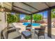 Relaxing outdoor patio with comfortable seating area overlooking a sparkling blue swimming pool at 506 W Seldon Ln, Phoenix, AZ 85021