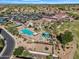 Aerial view of a vibrant community with a beautiful pool, meticulously landscaped grounds, and lush golf course views at 5312 S Citrus Ct, Gilbert, AZ 85298