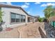 Spacious backyard featuring desert landscaping, stone accents, and a covered patio with a ceiling fan at 5312 S Citrus Ct, Gilbert, AZ 85298
