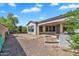 A lush backyard with multiple seating areas, desert landscaping, and covered patio at 5312 S Citrus Ct, Gilbert, AZ 85298
