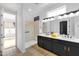 Bright bathroom features double sinks, black hardware, walk-in shower, and granite counters at 5312 S Citrus Ct, Gilbert, AZ 85298