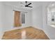 Light-filled bedroom with wood floors, ceiling fan, and large windows at 5312 S Citrus Ct, Gilbert, AZ 85298