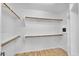 Bright walk-in closet with hardwood floors and custom shelving at 5312 S Citrus Ct, Gilbert, AZ 85298