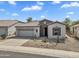 Charming home with a well-manicured front yard, stone accents, desert landscaping, and a two-car garage at 5312 S Citrus Ct, Gilbert, AZ 85298