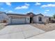Well-maintained home featuring a two-car garage, desert landscaping, and attractive architectural details at 5312 S Citrus Ct, Gilbert, AZ 85298