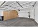 Spacious garage with finished ceiling, storage cabinets, utility sink, and door to the side yard at 5312 S Citrus Ct, Gilbert, AZ 85298