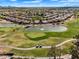 Scenic aerial view of a well-manicured golf course with lush greens and tranquil pond for a serene golfing experience at 5312 S Citrus Ct, Gilbert, AZ 85298