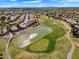 Overhead view of a stunning golf course featuring a tranquil pond and lush greens, offering a picturesque golfing experience at 5312 S Citrus Ct, Gilbert, AZ 85298