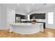 Modern kitchen with black cabinets, a quartz countertop, and stainless steel appliances at 5312 S Citrus Ct, Gilbert, AZ 85298