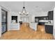 Open concept kitchen and living room with a chandelier, hardwood floors, and a fireplace at 5312 S Citrus Ct, Gilbert, AZ 85298