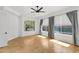 Bright living room with wood floors, large windows, and stylish window coverings at 5312 S Citrus Ct, Gilbert, AZ 85298