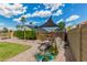 Backyard with a decorative pond, mature landscaping, and a shade sail for comfortable outdoor relaxation at 5601 W Whitten St, Chandler, AZ 85226
