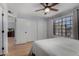 A light-filled bedroom featuring hardwood floors and a large window at 5601 W Whitten St, Chandler, AZ 85226