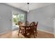 Cozy dining area featuring a wooden table with chairs and sliding door to outdoor area at 5601 W Whitten St, Chandler, AZ 85226