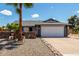 Charming single-Gathering home with a two-car garage and desert landscaping, including a tall palm tree at 5601 W Whitten St, Chandler, AZ 85226