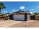 Well-maintained home with a two-car garage, desert landscaping and palm trees at 5601 W Whitten St, Chandler, AZ 85226
