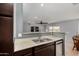 A modern kitchen features stainless steel appliances and beautiful dark wood cabinetry at 5601 W Whitten St, Chandler, AZ 85226