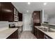 Bright kitchen showcasing stainless steel appliances and stunning dark wood cabinets at 5601 W Whitten St, Chandler, AZ 85226