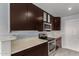 A chef's kitchen offering stainless steel appliances and beautiful dark wood cabinetry at 5601 W Whitten St, Chandler, AZ 85226