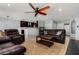 Inviting living room with hardwood flooring, with open bar to kitchen and large leather sofas at 5601 W Whitten St, Chandler, AZ 85226