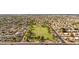 Aerial view of a well-maintained neighborhood with lush green spaces and mature trees, near community park at 630 W Navarro Ave, Mesa, AZ 85210