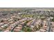 Wide aerial shot reveals the area's proximity to golf course and nearby businesses at 630 W Navarro Ave, Mesa, AZ 85210