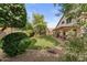Spacious backyard with lush lawn, mature trees, and a covered patio perfect for enjoying outdoor living at 630 W Navarro Ave, Mesa, AZ 85210