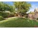 Well-maintained backyard featuring mature trees and shrubs, providing a serene and private outdoor space at 630 W Navarro Ave, Mesa, AZ 85210