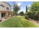 Expansive backyard featuring a lush lawn, mature landscaping, and a covered patio perfect for outdoor living at 630 W Navarro Ave, Mesa, AZ 85210