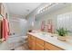 Bright bathroom featuring a vanity, shower-tub combo, and updated fixtures at 630 W Navarro Ave, Mesa, AZ 85210