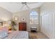 Bedroom featuring large window, ceiling fan, and mirrored closet doors at 630 W Navarro Ave, Mesa, AZ 85210