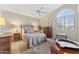 Bedroom with a large arched window, patterned rug, and ceiling fan at 630 W Navarro Ave, Mesa, AZ 85210