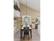 Bright dining room with vaulted ceilings, wood-look tile floors, and modern chandelier at 630 W Navarro Ave, Mesa, AZ 85210
