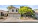 Charming two-story home with a well-manicured lawn and a two-car garage at 630 W Navarro Ave, Mesa, AZ 85210