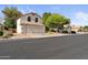 Charming two-story home featuring a two-car garage, manicured lawn, and mature trees in a suburban setting at 630 W Navarro Ave, Mesa, AZ 85210
