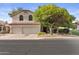 Beautiful home with a two-car garage, tile roof, arched windows and a well maintained lawn at 630 W Navarro Ave, Mesa, AZ 85210