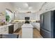 Modern kitchen featuring white cabinets, stainless steel appliances, and wood flooring at 630 W Navarro Ave, Mesa, AZ 85210