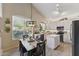 Open-concept kitchen with stainless steel appliances and wood flooring at 630 W Navarro Ave, Mesa, AZ 85210