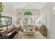 Well-lit living room with large windows, a decorative piano, and comfortable seating at 630 W Navarro Ave, Mesa, AZ 85210