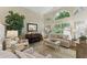 Bright living room featuring neutral tones, large windows, and a decorative piano at 630 W Navarro Ave, Mesa, AZ 85210