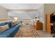 Cozy loft with a blue couch, desk, and natural light at 630 W Navarro Ave, Mesa, AZ 85210